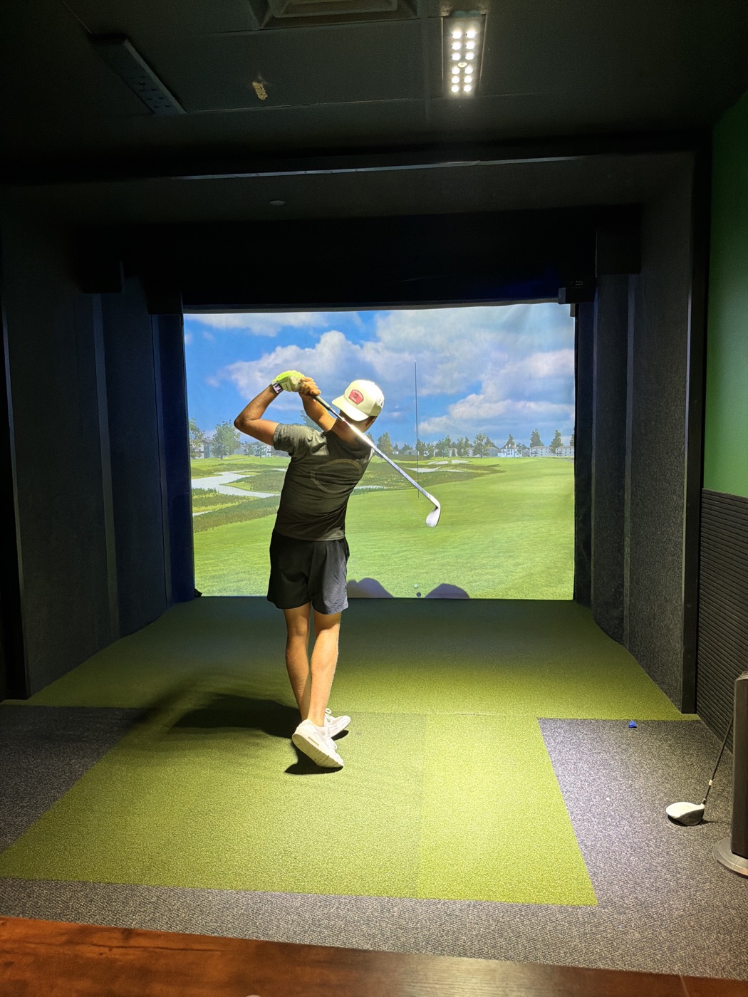 Golfer following through on a swing at One Swing Away in Queen Creek